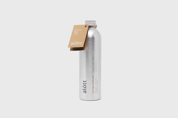 Tall metal bottle with printed logo and paper tag on grey background