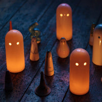 Glowing ceramic candle holders in dark room